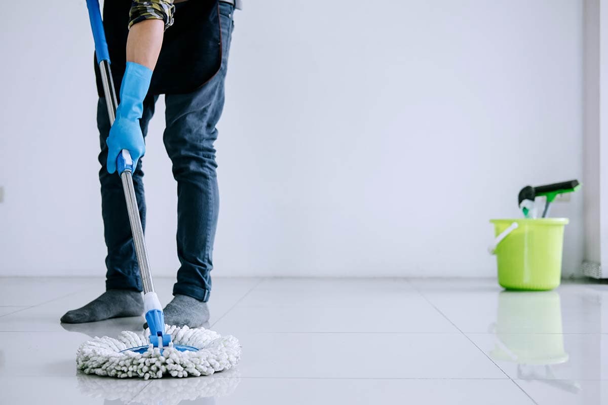 parkland residential & commercial cleaners - husband housekeeping and cleaning concept happy young man in blue rubber gloves wiping dust using mop t20 Kv12QE 1 - Parkland Residential &#038; Commercial Cleaners